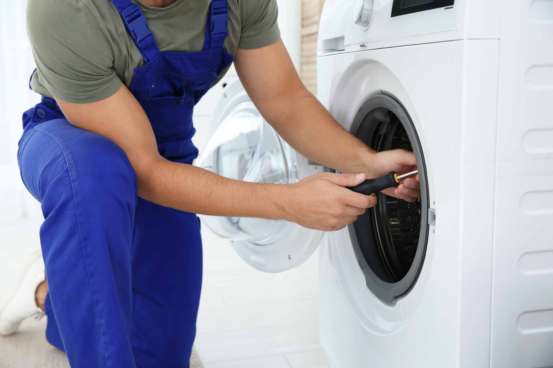 a man fixing a dryer