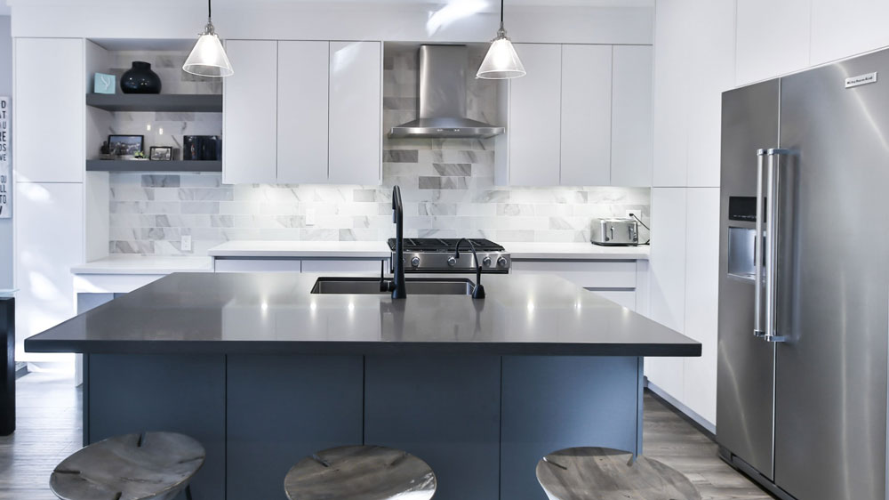 a modern kitchen with stainless steel appliances and white cabinets.