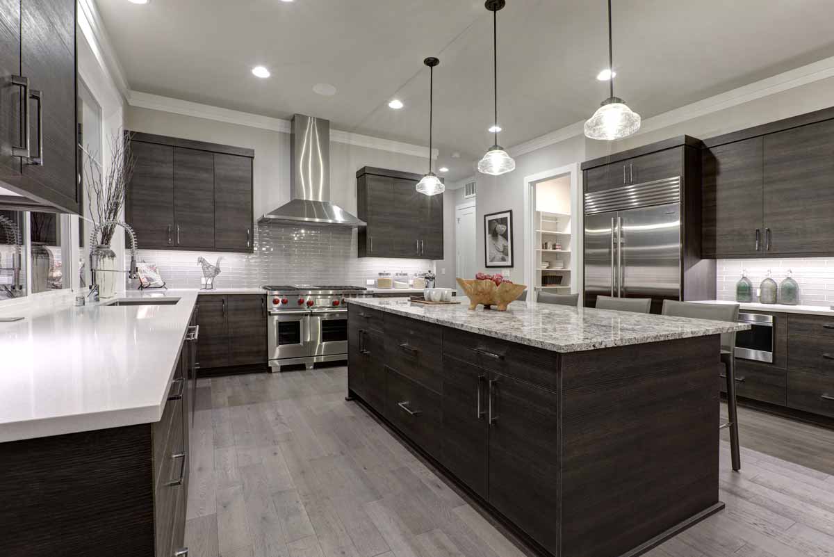 a large kitchen with a center island in the middle of the room.