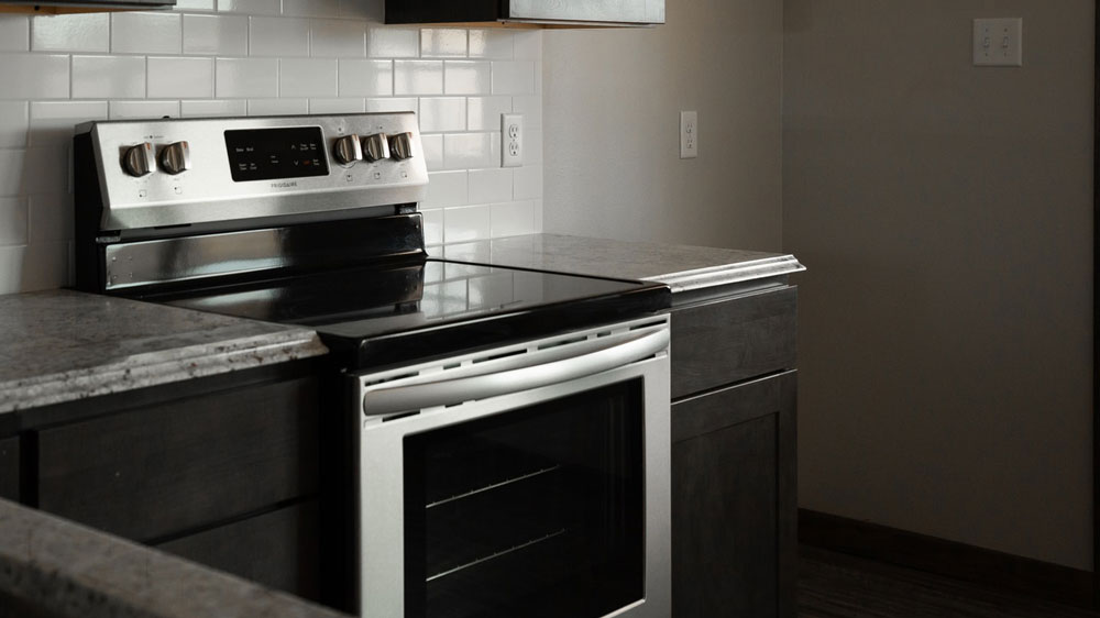 a kitchen with a stove, oven and cabinets.